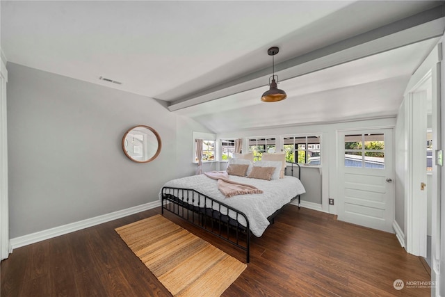 bedroom featuring dark hardwood / wood-style floors and lofted ceiling with beams