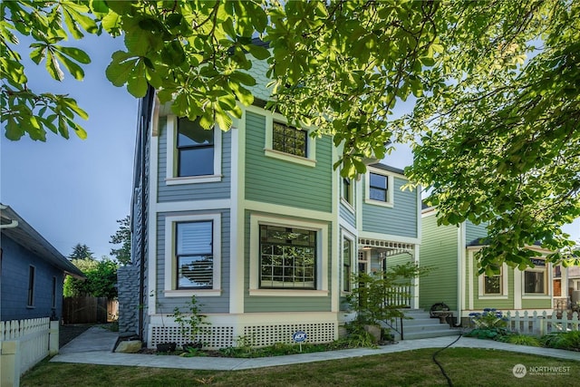 rear view of property with a lawn