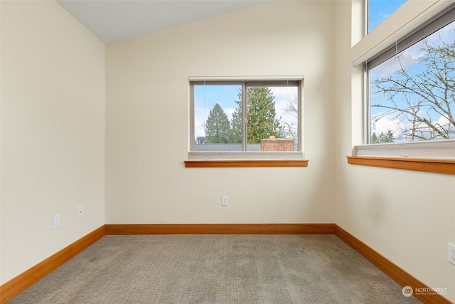 empty room with carpet and lofted ceiling