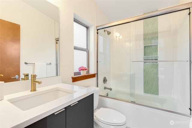 full bathroom with vanity, shower / bath combination with glass door, and toilet