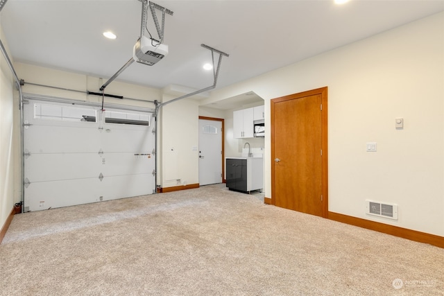 garage featuring a garage door opener and washer and dryer