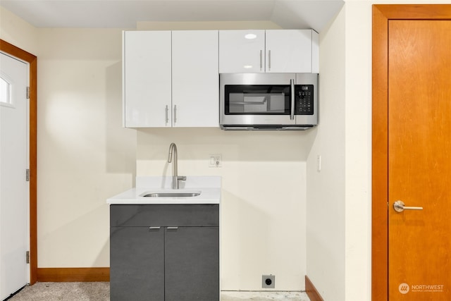 kitchen with sink and white cabinetry