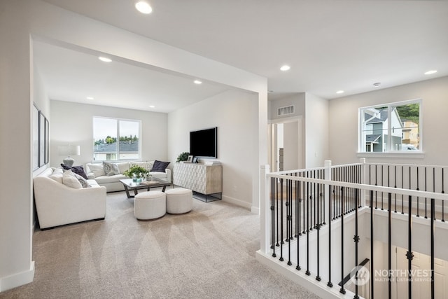 carpeted living room with plenty of natural light