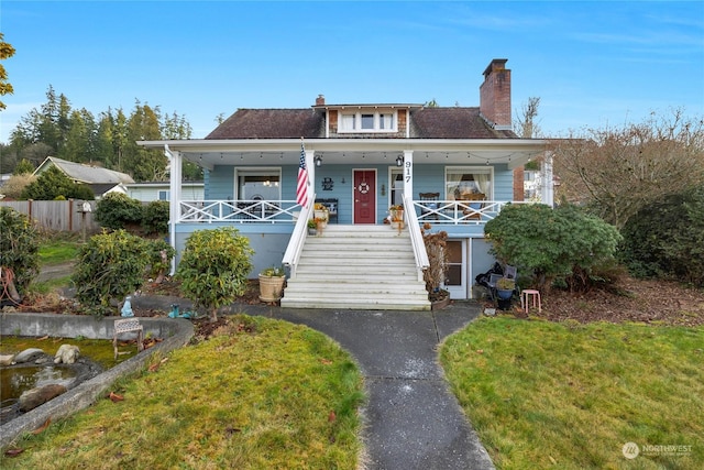 bungalow-style house with covered porch and a front yard