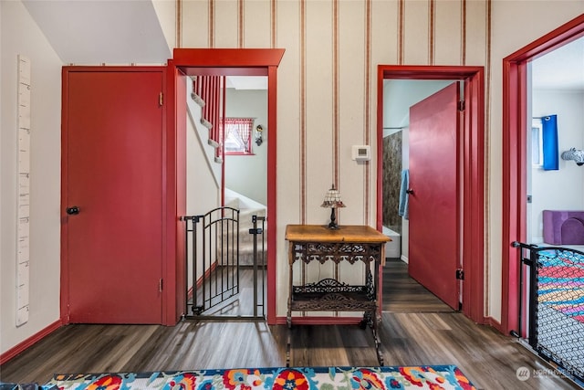 hallway with dark hardwood / wood-style floors