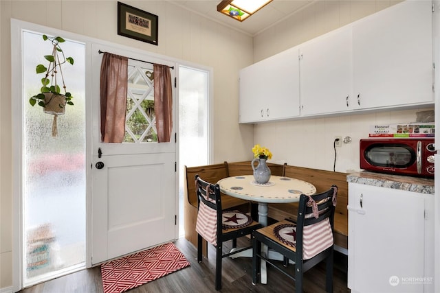 dining space with dark wood-type flooring