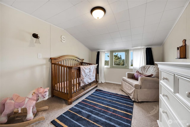 bedroom featuring a nursery area and carpet