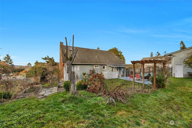 back of house with a yard, a pergola, and a patio area