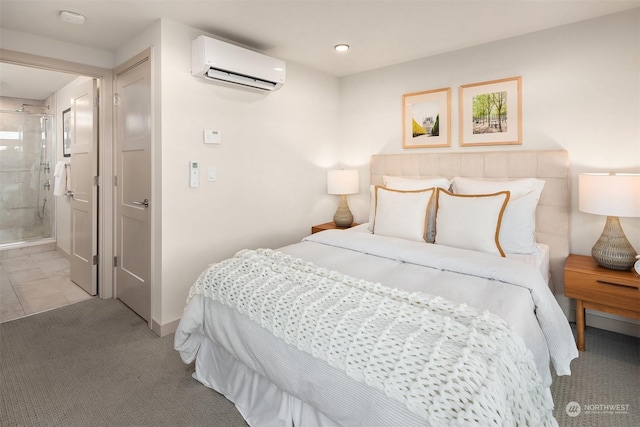 carpeted bedroom featuring ensuite bathroom and an AC wall unit