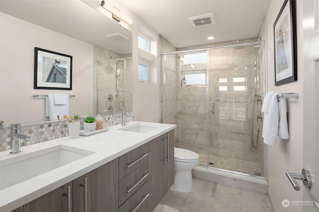 bathroom featuring toilet, vanity, and an enclosed shower