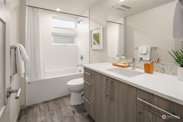 full bathroom with toilet, shower / tub combo, vanity, and hardwood / wood-style floors