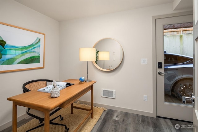 home office with dark hardwood / wood-style flooring