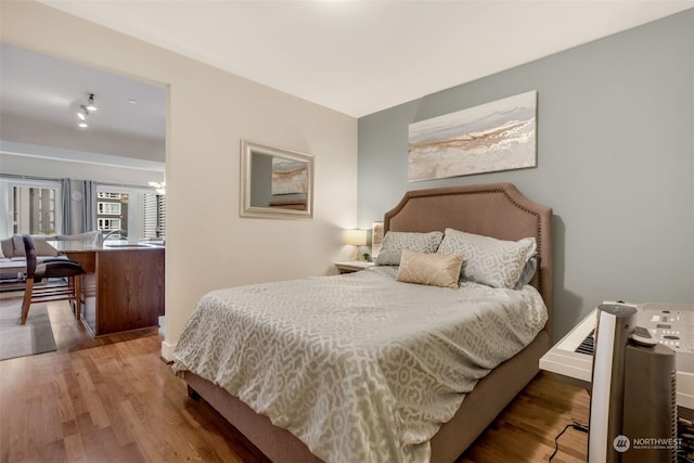 bedroom with hardwood / wood-style floors