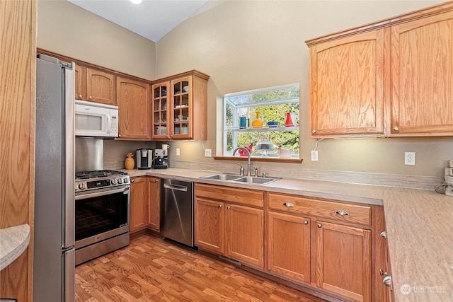 kitchen featuring sink, appliances with stainless steel finishes, and light wood-type flooring