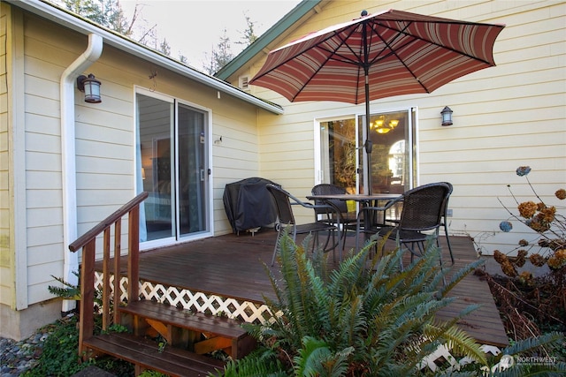 wooden deck featuring a grill