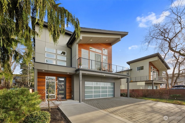 view of front of home featuring a garage and a balcony