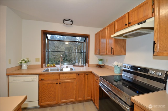 kitchen with dishwasher, stainless steel electric range oven, light countertops, under cabinet range hood, and a sink