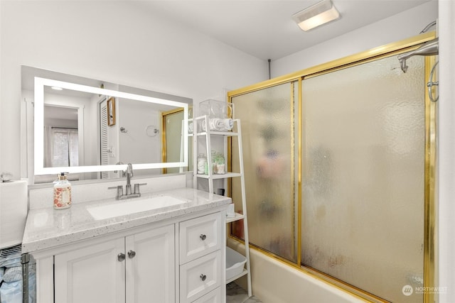 bathroom with vanity and shower / bath combination with glass door