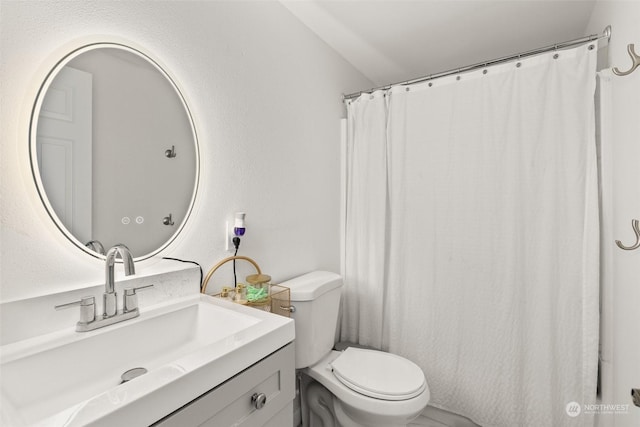 bathroom featuring toilet and vanity