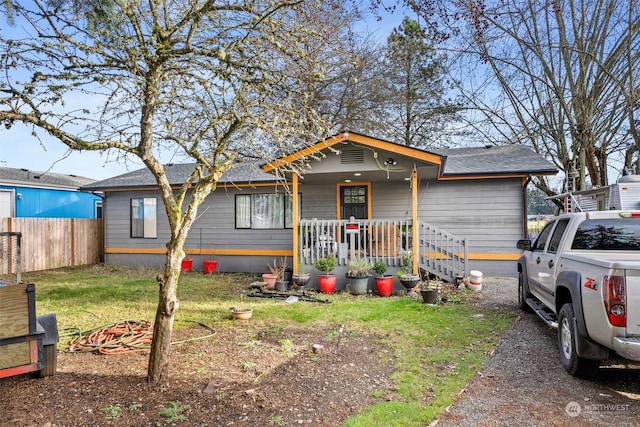 view of front of property featuring a front lawn and covered porch