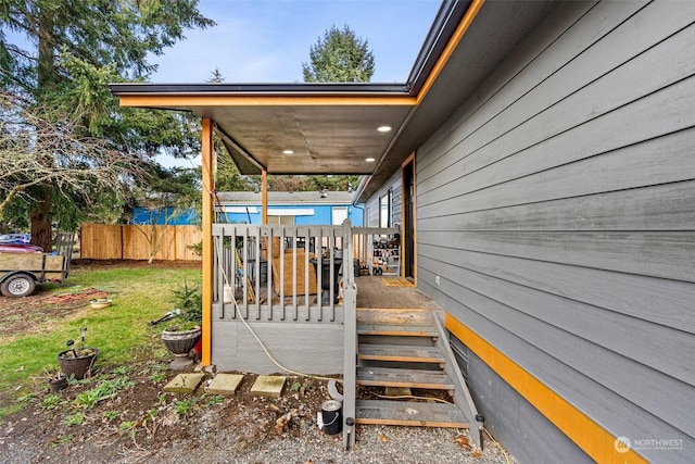 wooden deck featuring a lawn