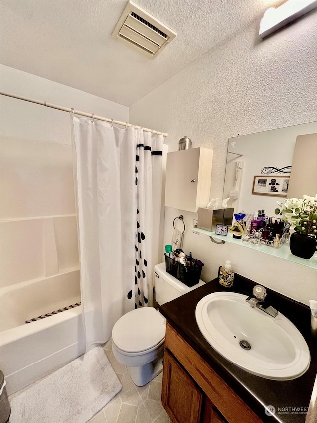 full bathroom with toilet, shower / bath combo with shower curtain, tile patterned floors, a textured ceiling, and vanity