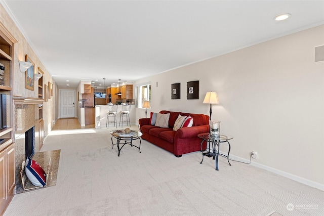 carpeted living room with crown molding and a fireplace