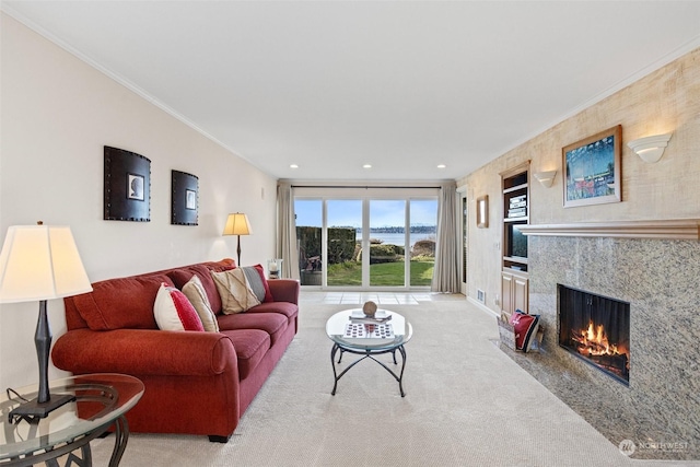 living room featuring ornamental molding, a fireplace, and light carpet