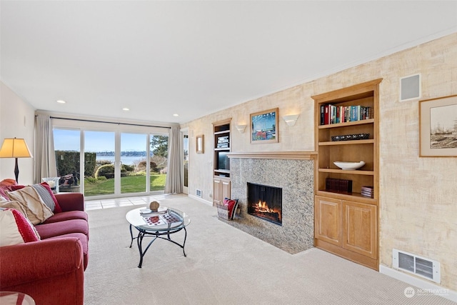 carpeted living room with built in features and a fireplace