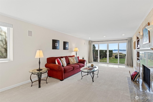 living room with light carpet, a fireplace, and ornamental molding