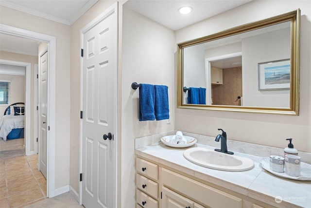 bathroom featuring crown molding, vanity, and tile patterned floors