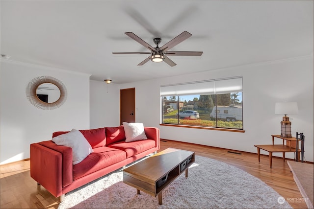 living room with light wood-type flooring and ceiling fan