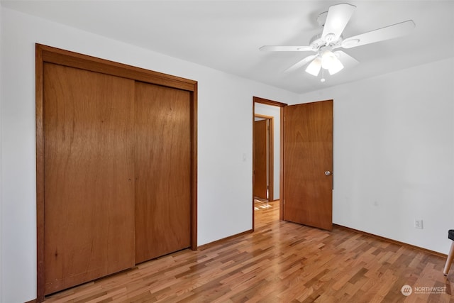 unfurnished bedroom with light wood-type flooring, a closet, and ceiling fan