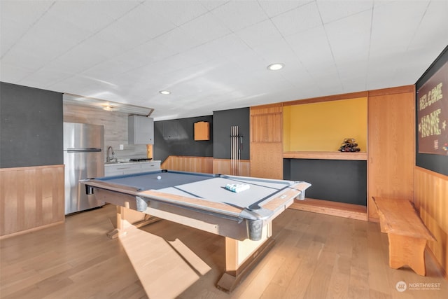 playroom featuring sink, billiards, light hardwood / wood-style flooring, and wooden walls