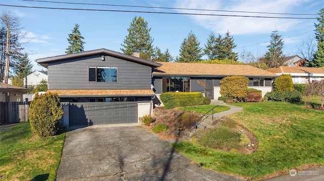 split level home with a garage and a front yard