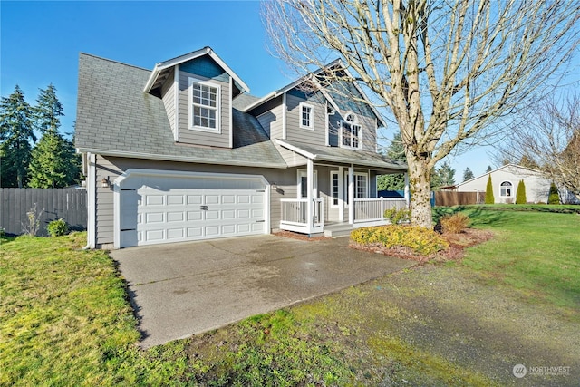 view of front of property with a porch, a garage, and a front lawn