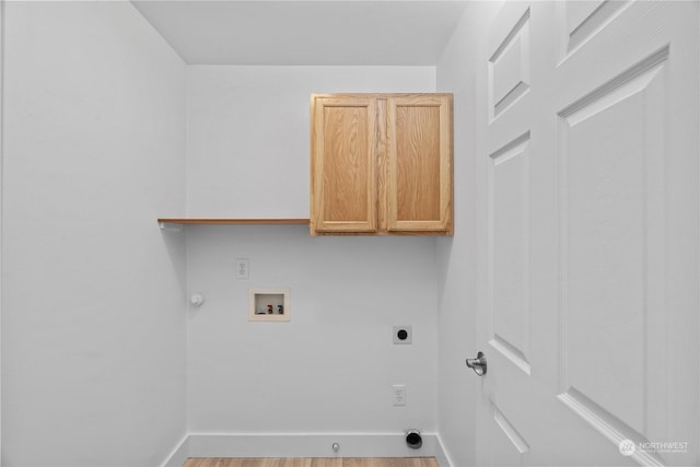 clothes washing area with wood-type flooring, hookup for a gas dryer, cabinets, washer hookup, and hookup for an electric dryer