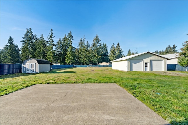 view of yard featuring a garage and a storage shed