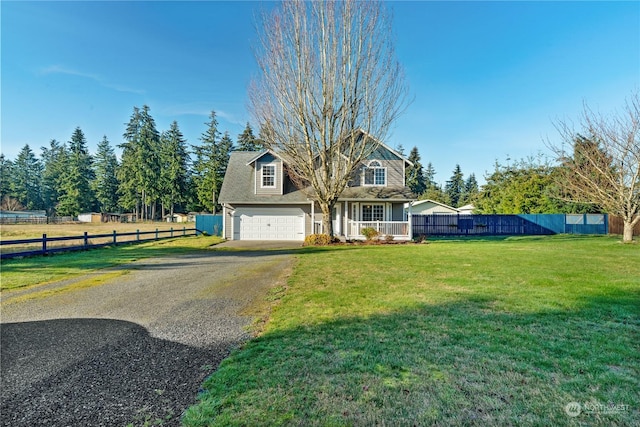 view of front facade with a garage, a front lawn, and covered porch