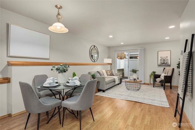 dining space with light hardwood / wood-style floors