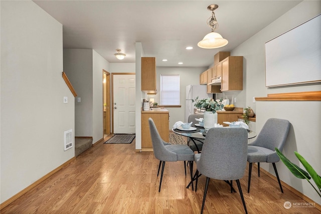 dining area with light hardwood / wood-style floors