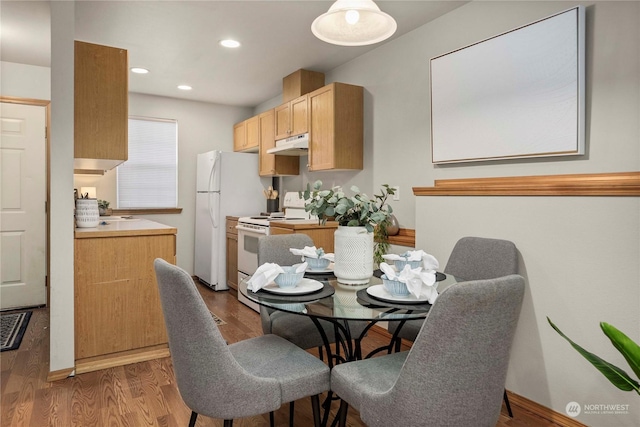 dining area with dark wood-type flooring