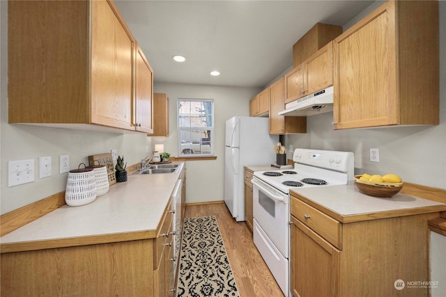 kitchen with sink, light wood-type flooring, white appliances, and light brown cabinets