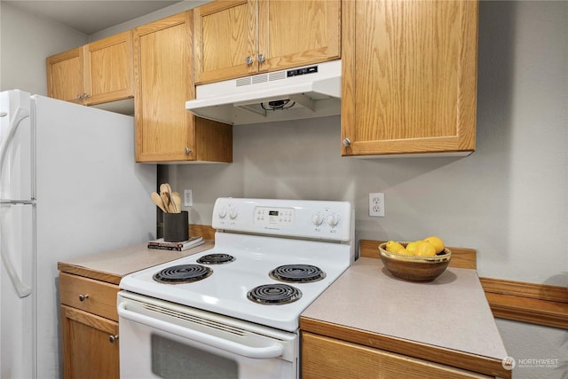 kitchen with light brown cabinets and white appliances