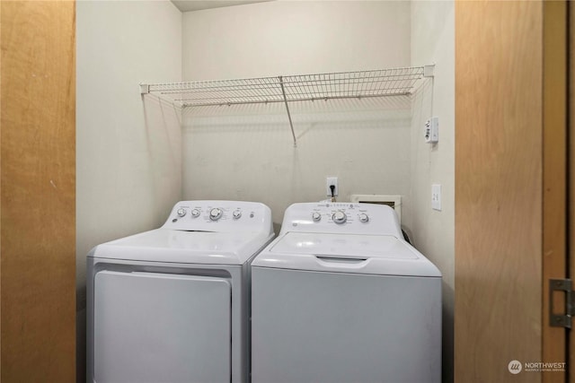 clothes washing area featuring separate washer and dryer