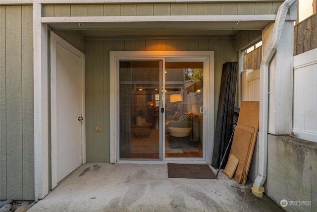 view of exterior entry featuring a patio area