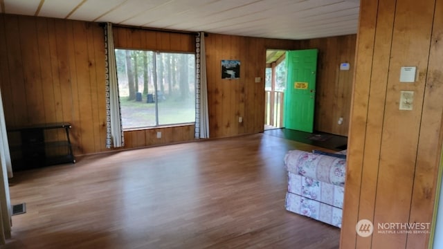 interior space with wooden walls and hardwood / wood-style floors