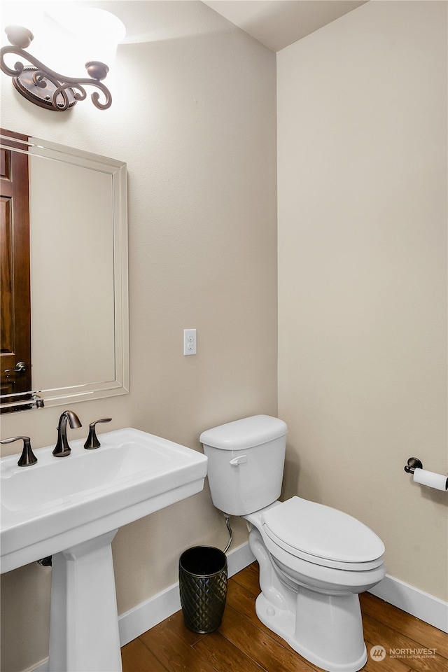 bathroom featuring sink, hardwood / wood-style flooring, and toilet