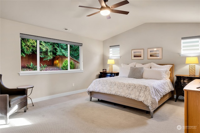 bedroom featuring vaulted ceiling, light carpet, and ceiling fan