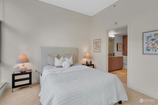 bedroom featuring light colored carpet and connected bathroom